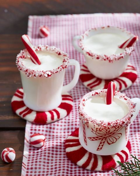peppermint eggnog in three white mugs with crushed peppermint around the rims