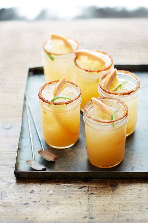 pink grapefruit margaritas in small mason jars with slices of fresh grapefruit and lime