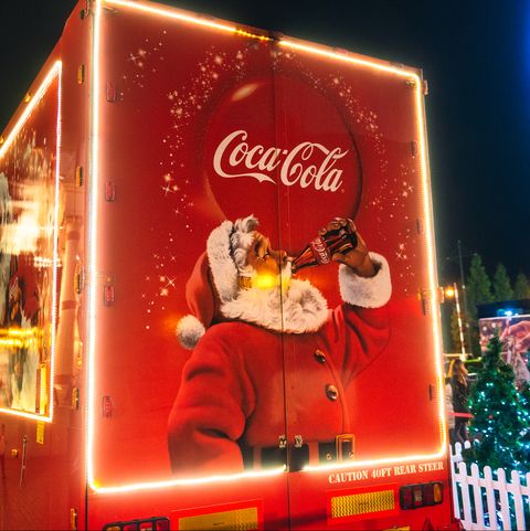 manchester, uk   an image of santa claus drinking coca cola on the back of the companys touring christmas marketing truck in manchester, england, with people in the background