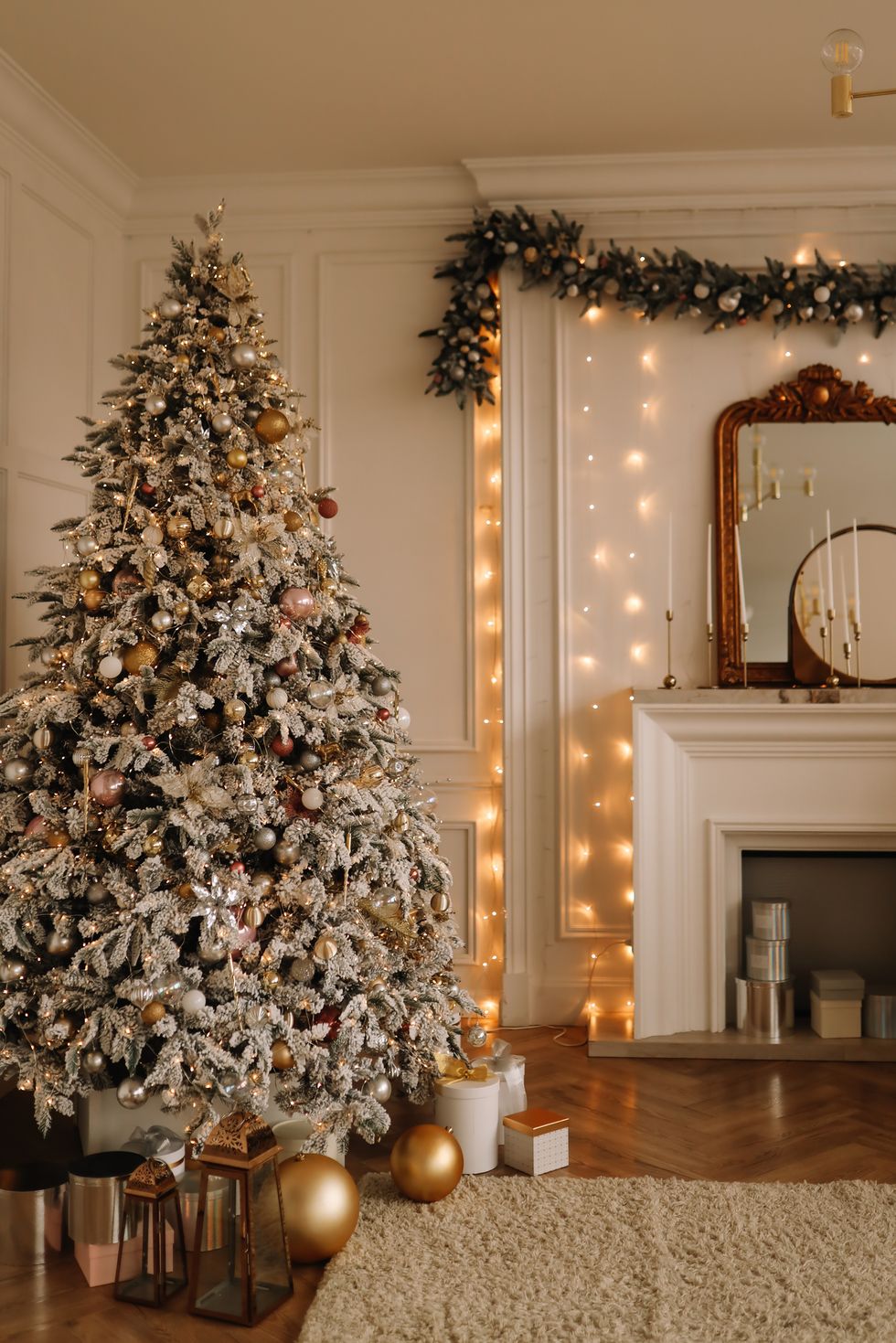 Christmas concept is a festive Christmas rich interior in luxury modern style with fireplace, decorated with Christmas balls and Christmas tree garlands in a large bright living room of an apartment on winter New Year's Eve.