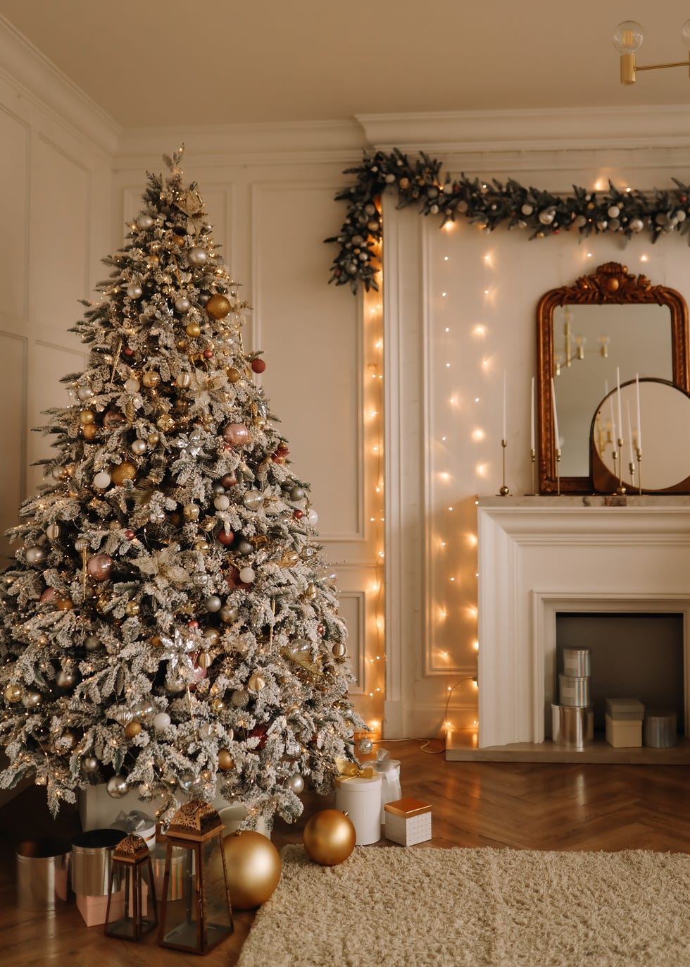 christmas concept festive christmas rich interior in a luxurious modern style with a fireplace and decorated with christmas balls and garlands of christmas trees in a large bright living room in the apartment on new year's eve in winter place for text