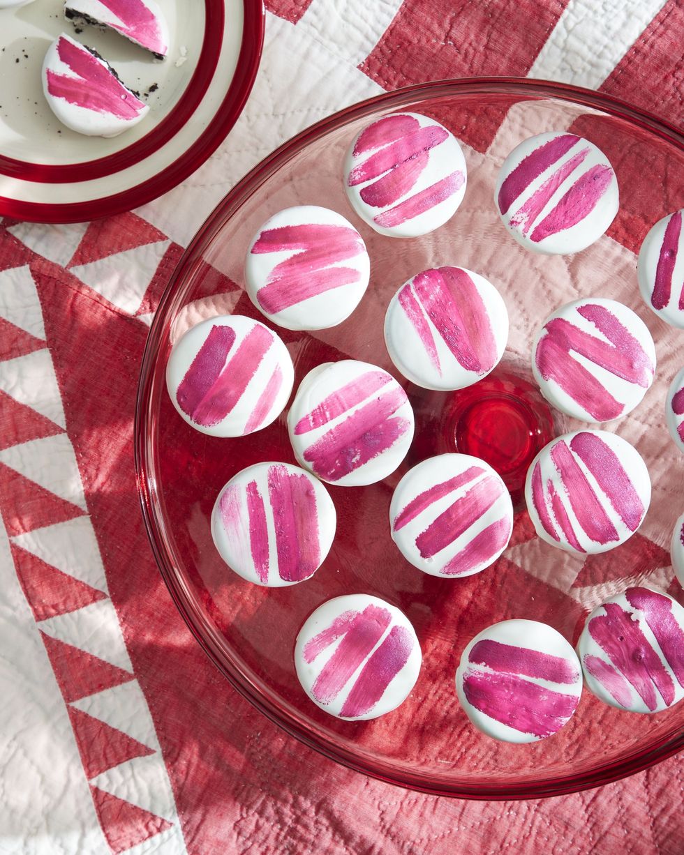 striped peppermint sandwich cookies on a red glass serving stand