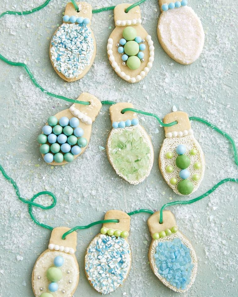 christmas light sugar cookies with various sprinkle and arranged on a licorice string