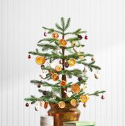 mini christmas tree with dried orange ornaments