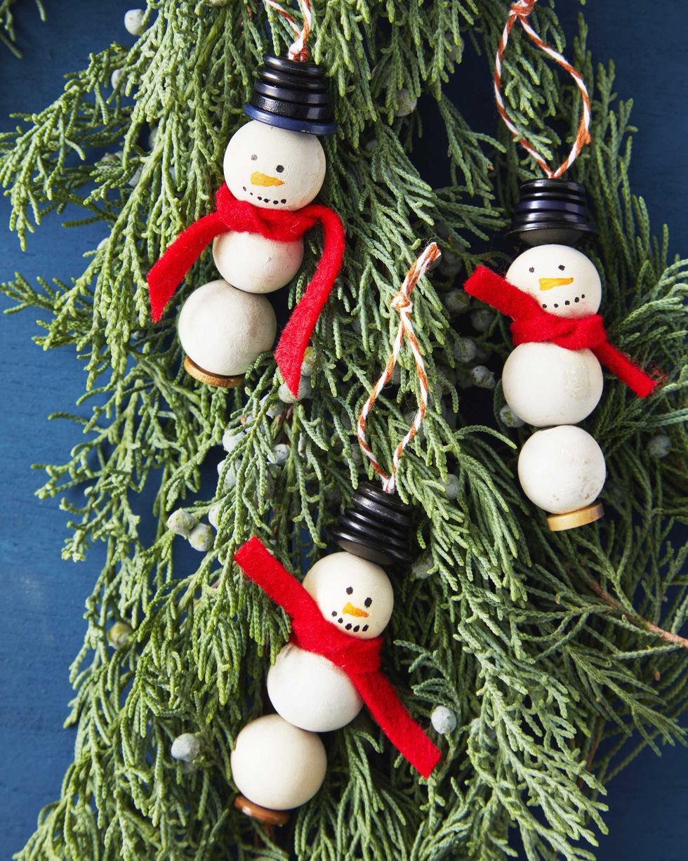 snowman made from craft balls with button hats and a red felt scarf