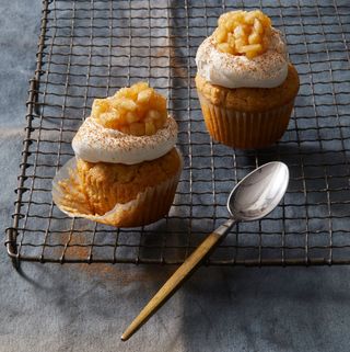 apple pie cupcakes with whipped cream and apples on top