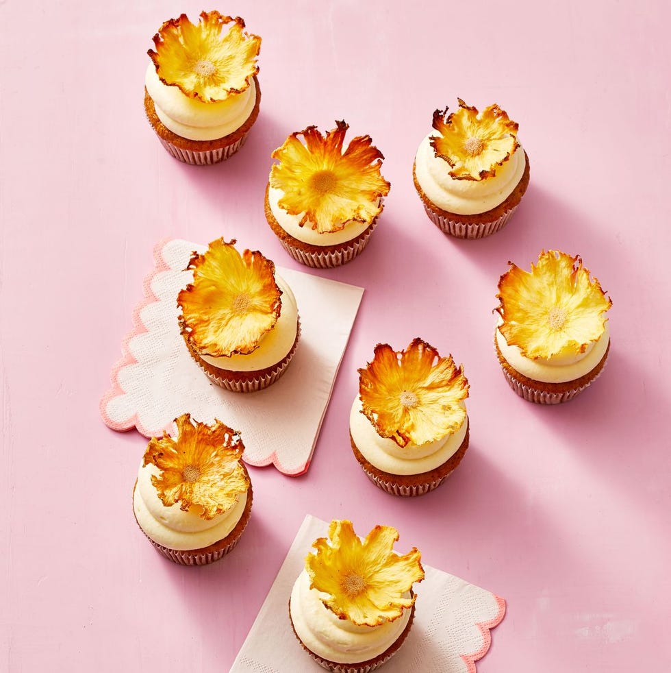 carrot pineapple cupcakes with dried pineapple flowers on top