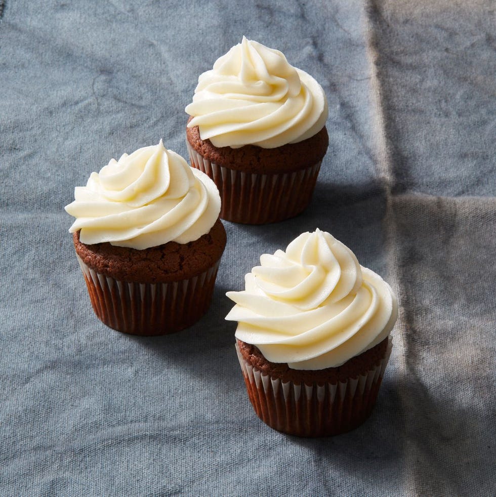 chocolate pecan cupcakes with white frosting on top