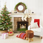 living room with stockings on the mantel, fireplace, christmas tree