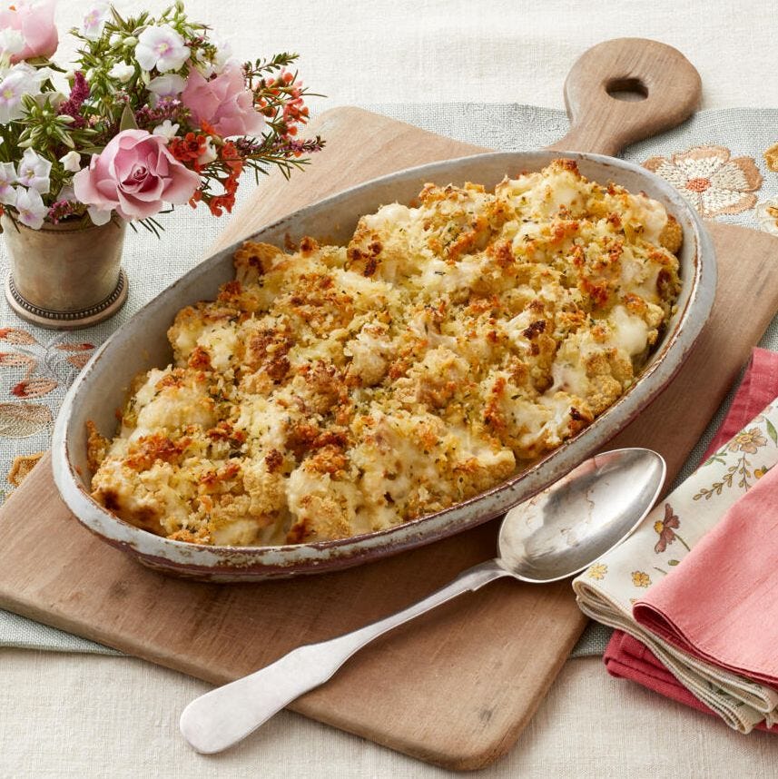 cauliflower gratin in dish on wooden board with spoon