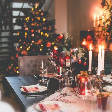 christmas dinner table at festive cozy room background with christmas tree