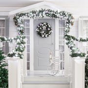 house entrance decorated for holidays. Christmas decoration. garland of fir tree branches and lights on the railing house entrance decorated for holidays christmas decoration garland of fir tree branches and lights on the railing