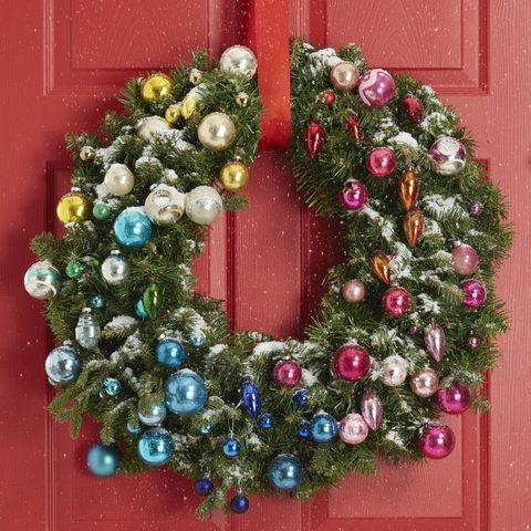 christmas party themes, a wreath full of ornaments is on the door