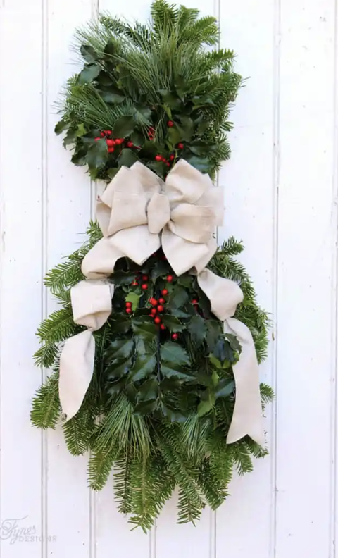 christmas door decorations, evergreen swag hanging on the wall
