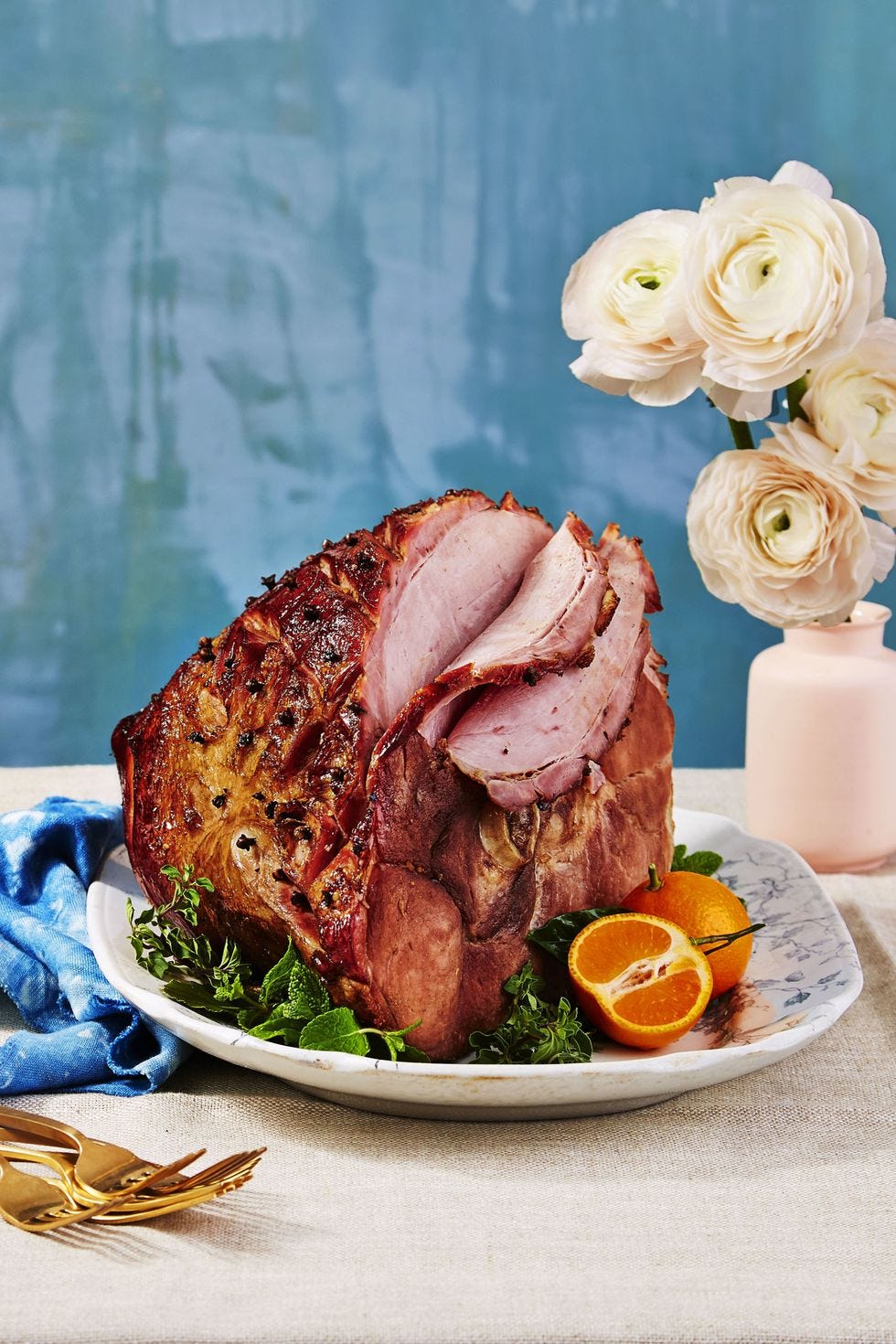 christmas foods   a root beer glazed ham on a platter with greens and oranges