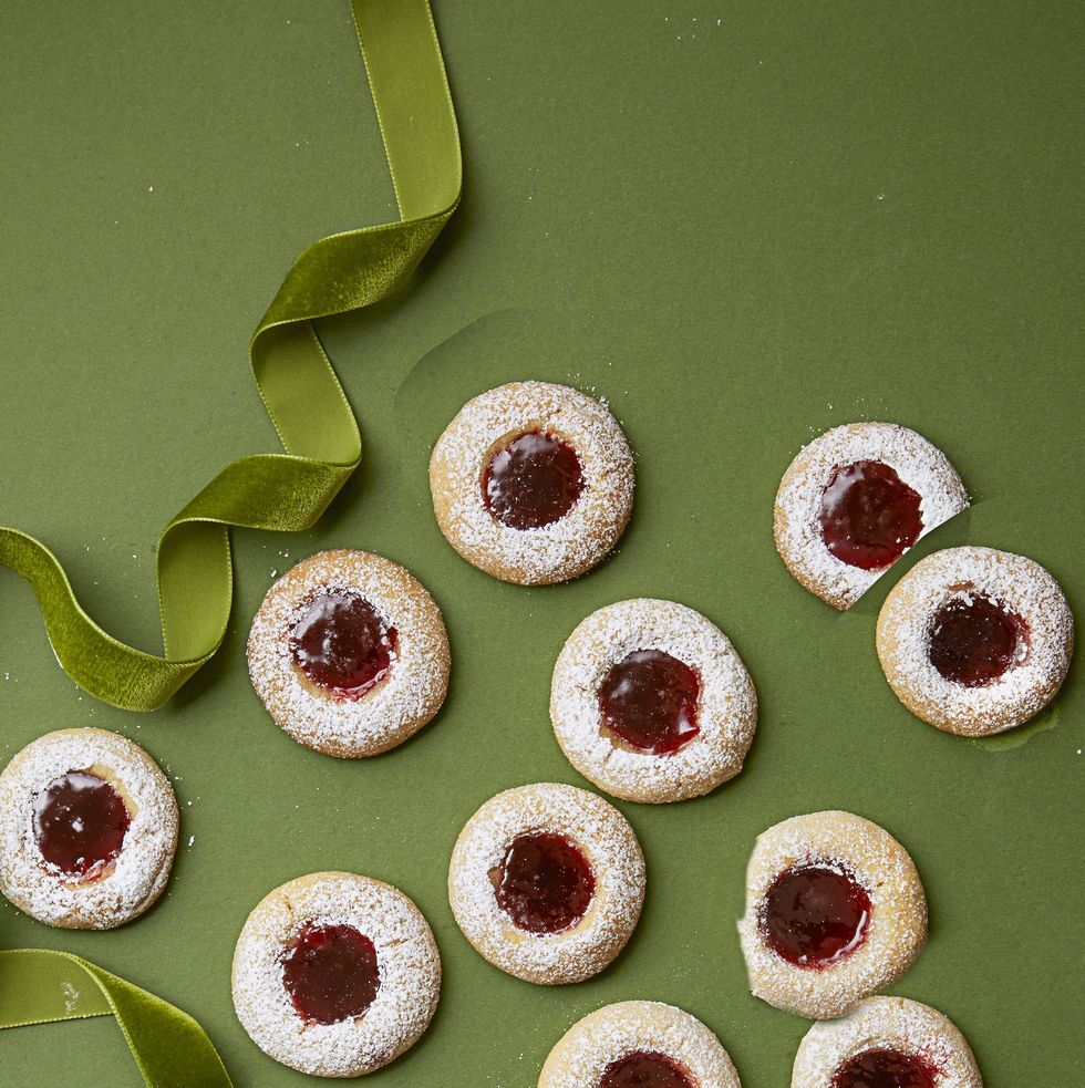 christmas foods   raspberry thumbprints with a green ribbon a green background