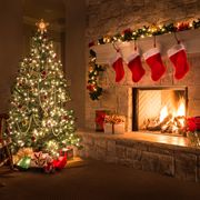 christmas glowing fireplace, hearth, tree red stockings gifts and decorations