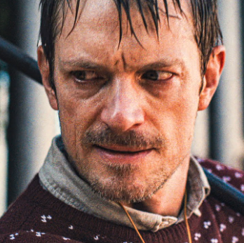 a man in a sweater looks angry in a scene from silent night