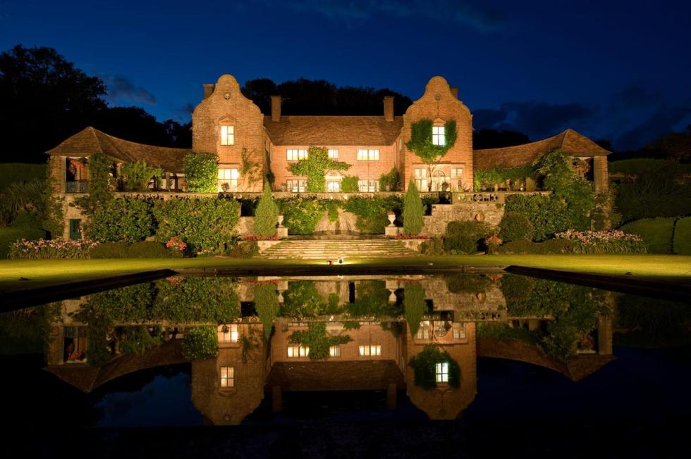 a house with a pond in front of it