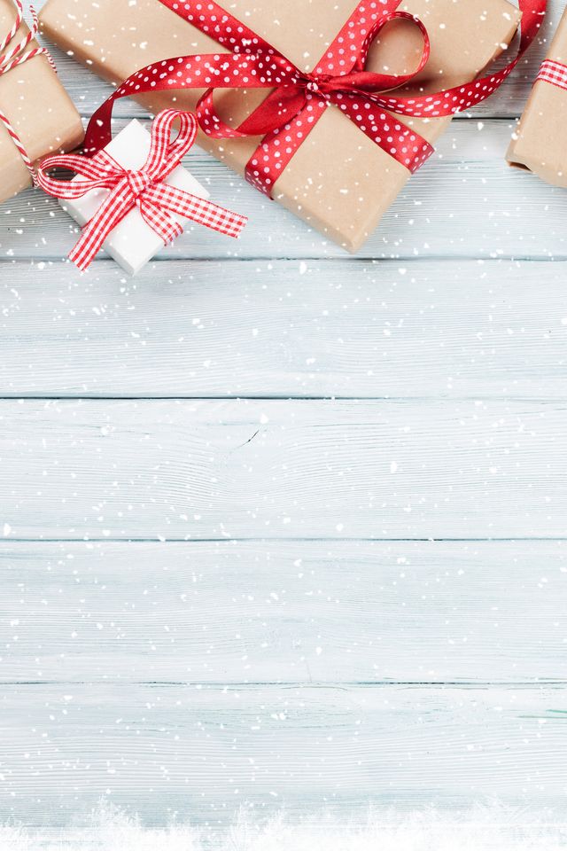 Christmas wooden background with gift boxes and snow