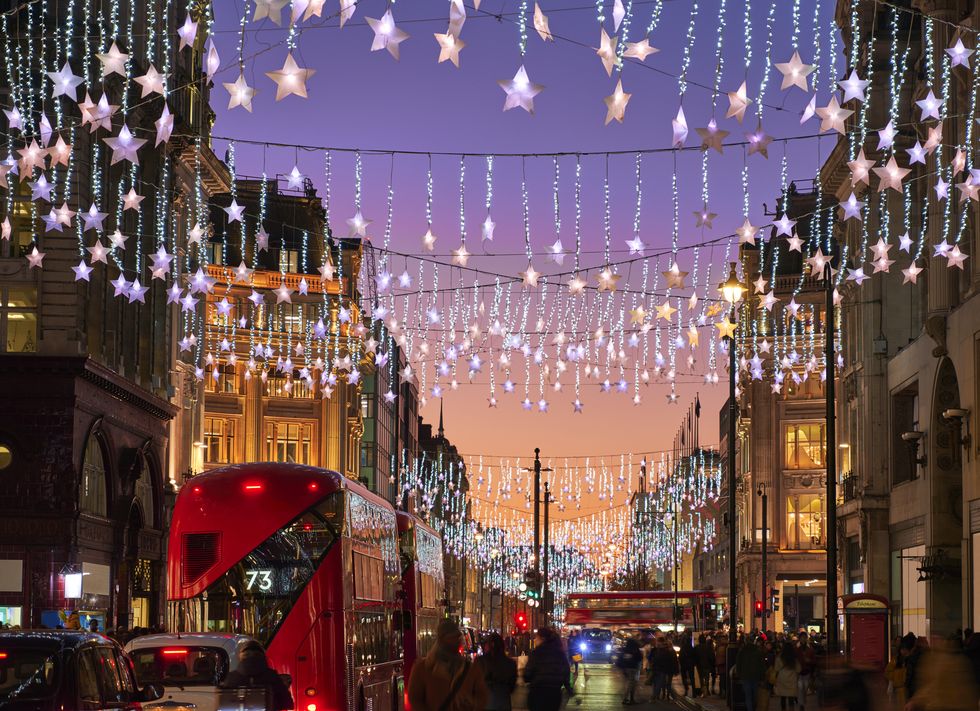 uk, london, oxford street, busy street at christmas with lights at dusk