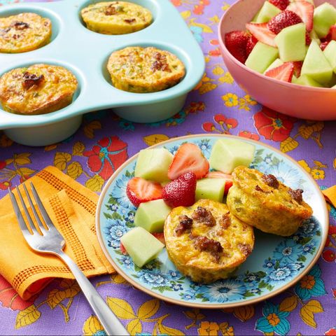 individual sausage casseroles on plate with fruit salad and in muffin tin