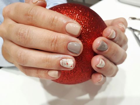 cropped hands of woman holding red bauble