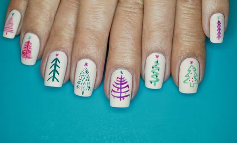 white painted nails with different christmas tree designs on each