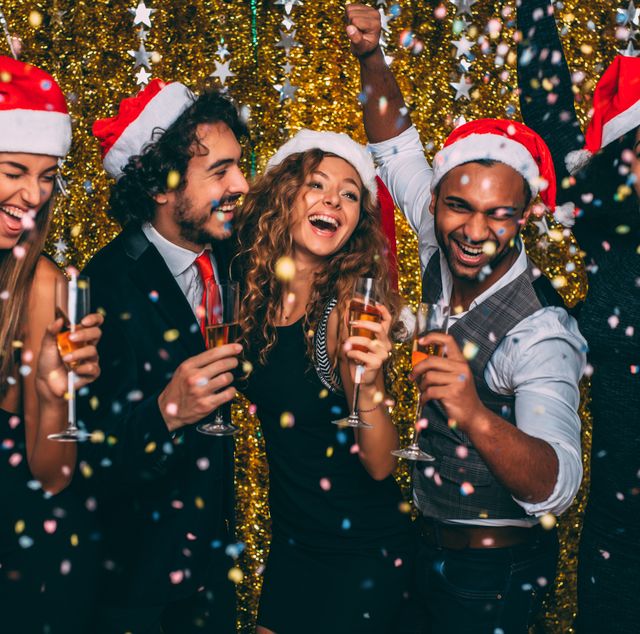 christmas party ideas, friends having a christmas party with gold sparkles and santa hats