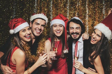 christmas party, young people celebrating christmas with santa hats and champagne