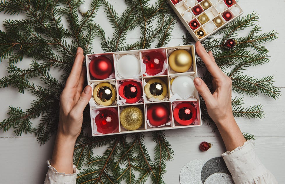 a box filled with red and gold christmas ornaments