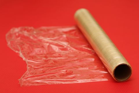 roll of plastic wrap on red background