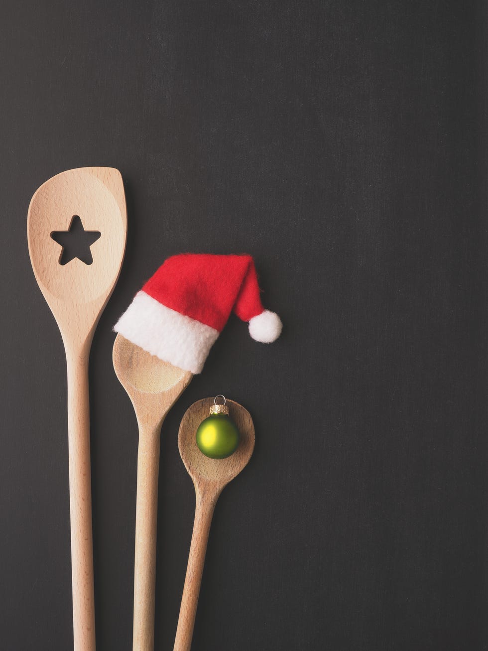 three wooden kitchen spoons in different sizes