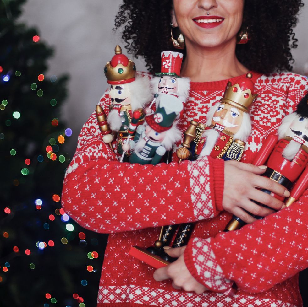 christmas party, portrait of woman holding nutcracker soldiers at christmas
