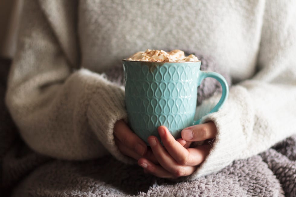 christmas party, woman holds a mug of hot cocoa