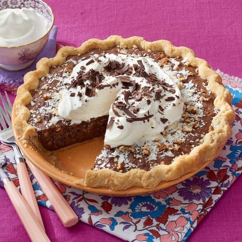 german chocolate pie with whipped cream on pink surface