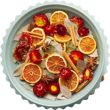 a decorative arrangement of dried fruits and spices in a round tray