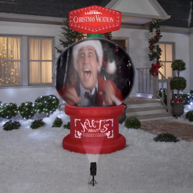 christmas vacation red lawn inflatable shaped like a globe with a scene from the movie projected on it