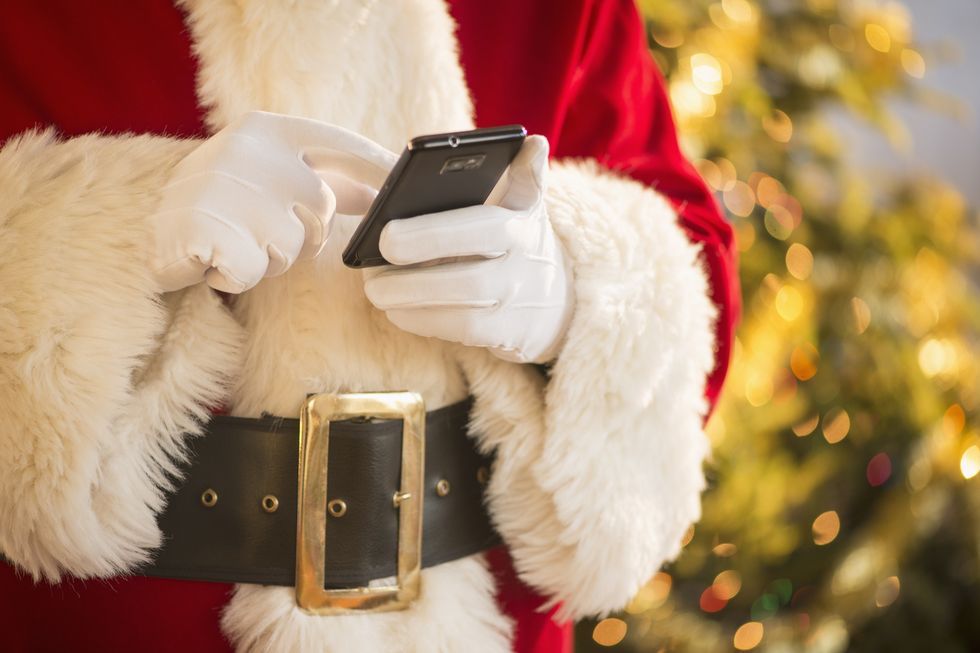 Santa claus holding cell phone