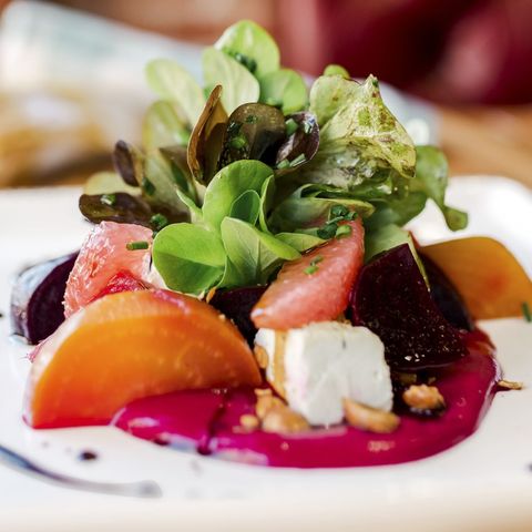roasted beet salad on white plate with greens