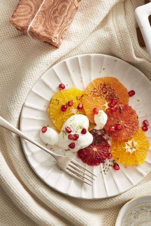 winter citrus fruit salad with pomegranate seeds on a white plate