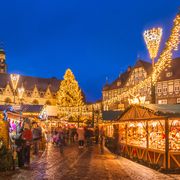 the traditional christmas market on the historic market square of goslar, germany at dusk