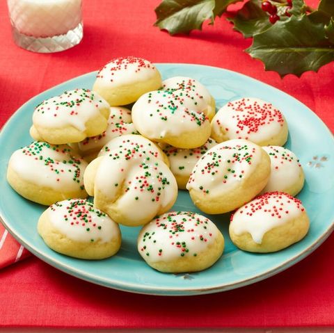 italian christmas cookies with red and green sprinkles on red background