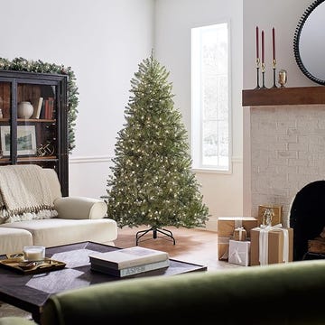 cozy living room decorated for christmas with a tree and gifts