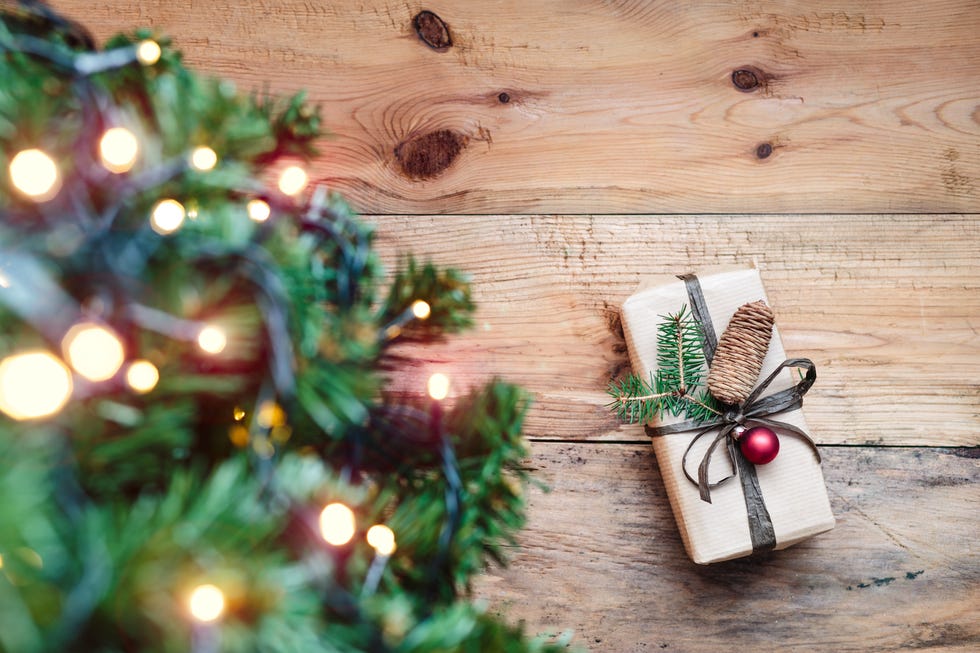 Christmas Tree And Gift On Wooden Table