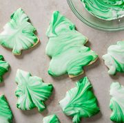christmas tree cookies decorated with tie dye style green and white swirl icing