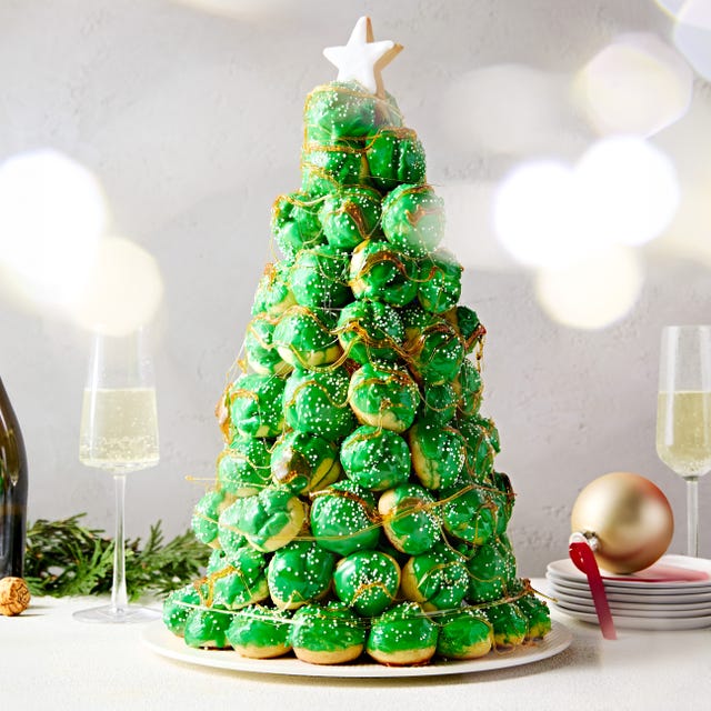 Christmas Tree Croquembouche a croquembouche shaped like a christmas tree adorned with green icing and edible decorations