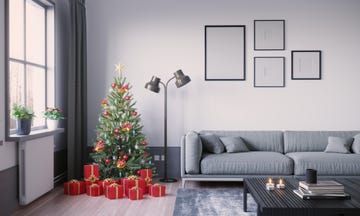 christmas tree for small apartment, green tree with ornaments and red presents underneath