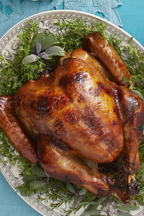 maple rosemary roast turkey on herbs with blue background
