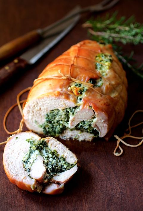 spinach and ricotta stuffed turkey breast on wood surface